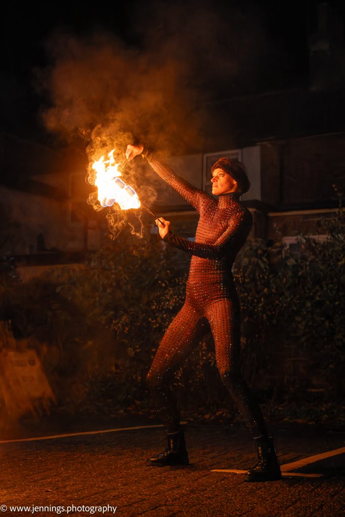 A woman is holding a fire torch.