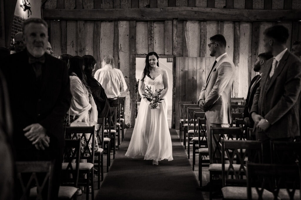 A bride walking down the aisle at a wedding.