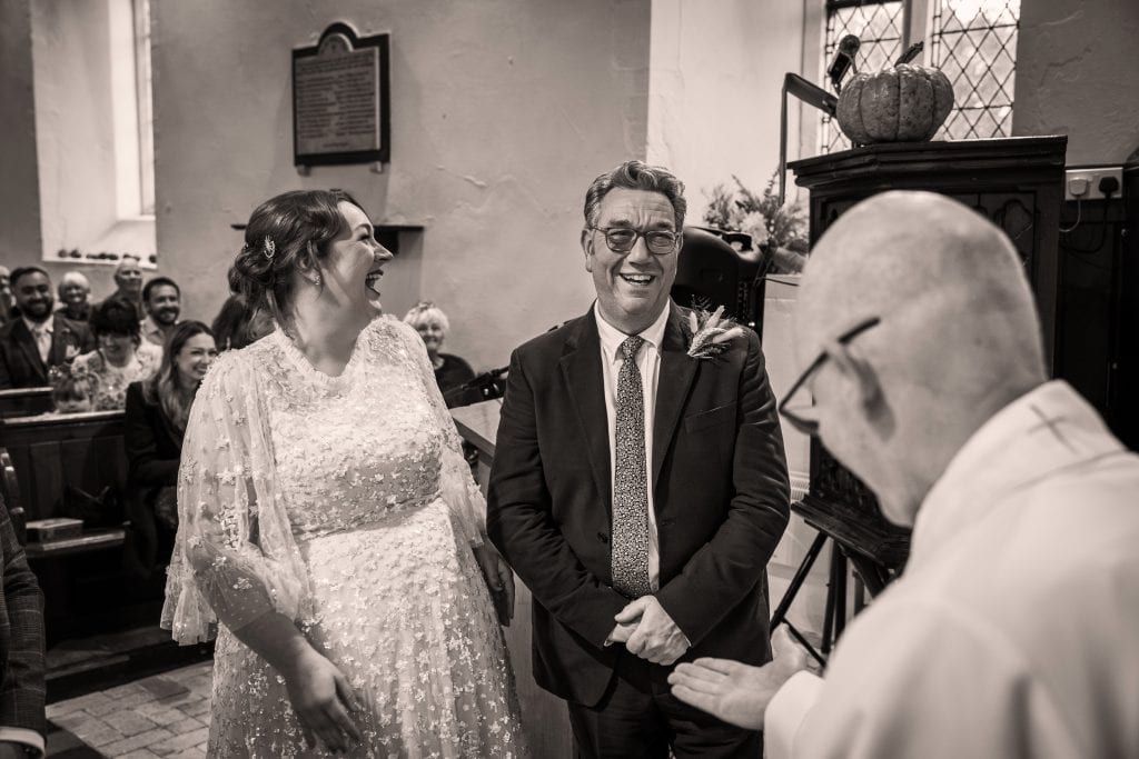 A man and woman stand together in All Saints Church.