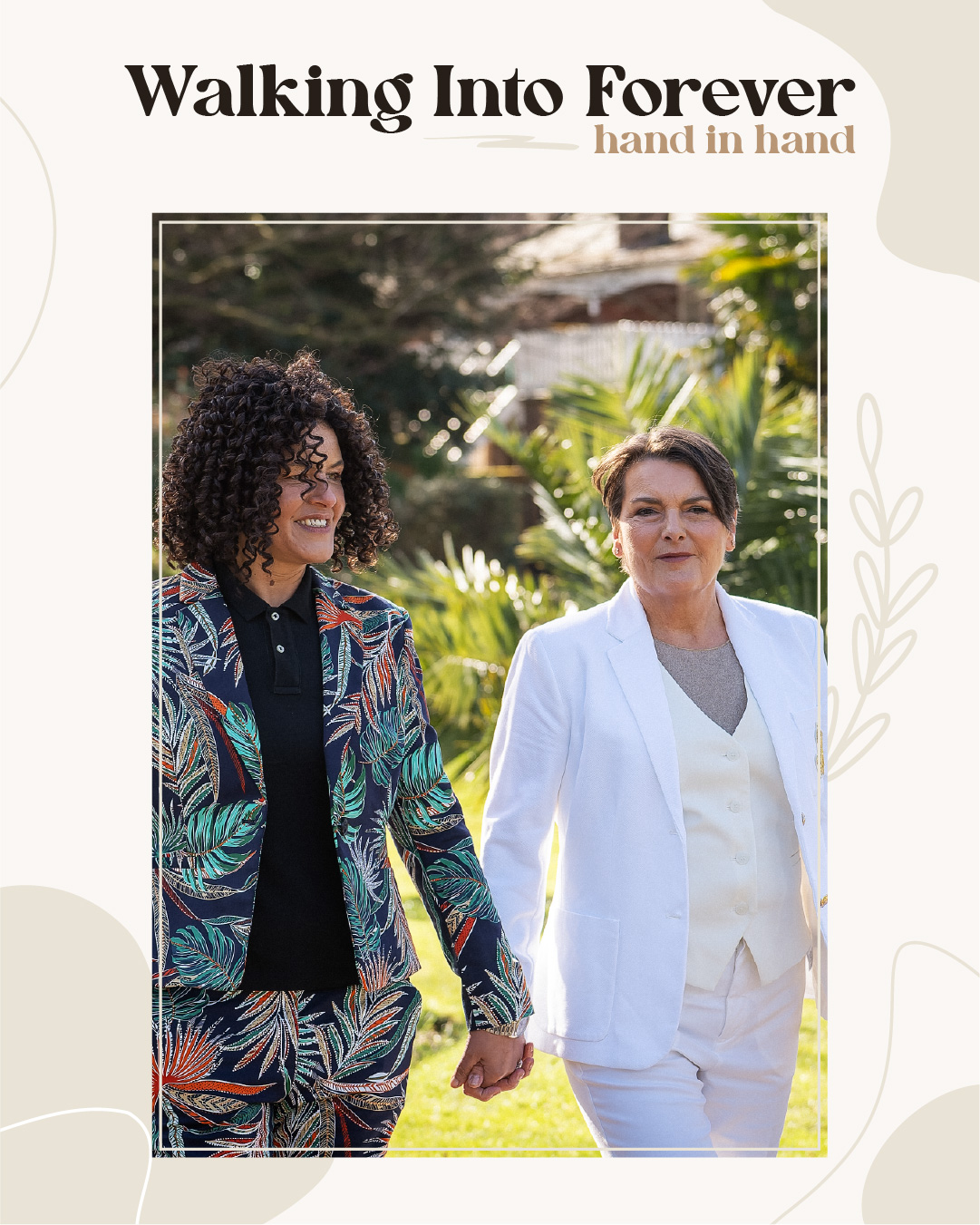 Two women in suits holding hands and walking outdoors, surrounded by greenery, with the text "Walking Into Forever hand in hand" above them. Wedding Photo taken by Jennings Photography