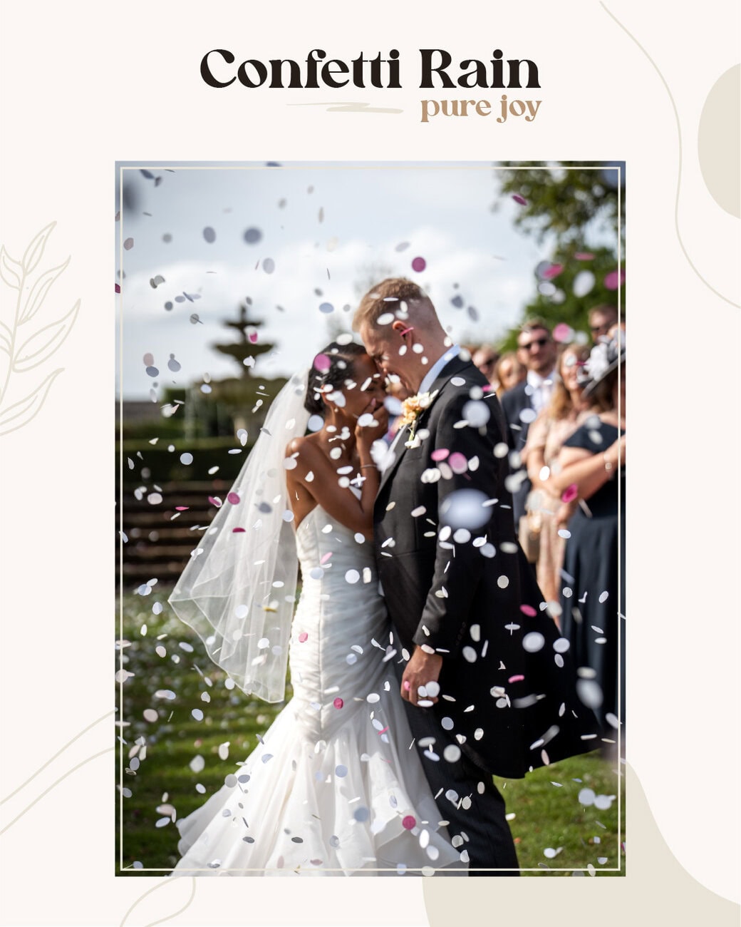 A bride and groom stand close together outdoors as pink and white confetti falls around them, with wedding guests watching in the background. Wedding Photo taken by Jennings Photography