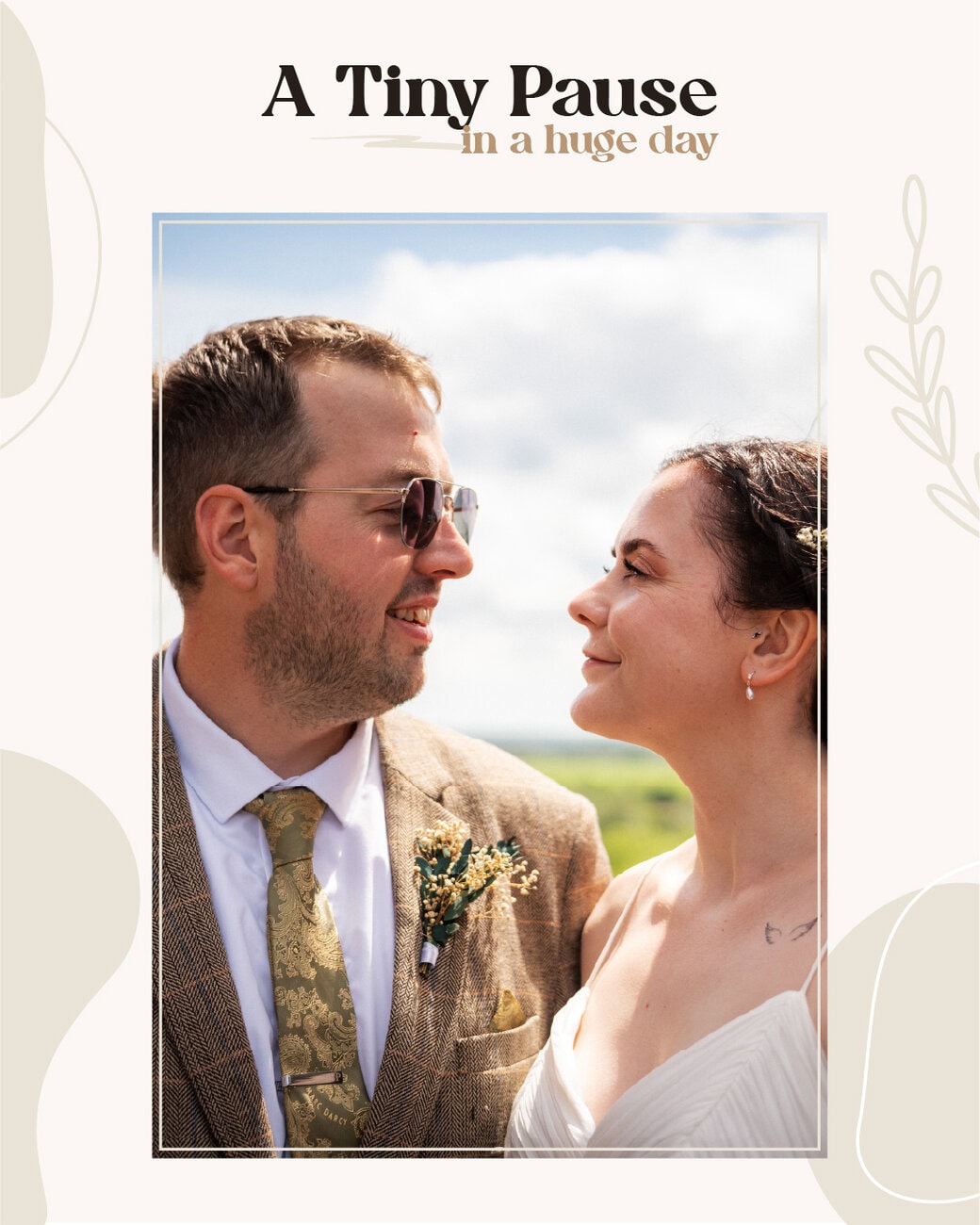 A man in a suit and a woman in a white dress stand close together outdoors, looking at each other and smiling, with text above reading "A Tiny Pause in a huge day. Wedding Photo taken by Jennings Photography
